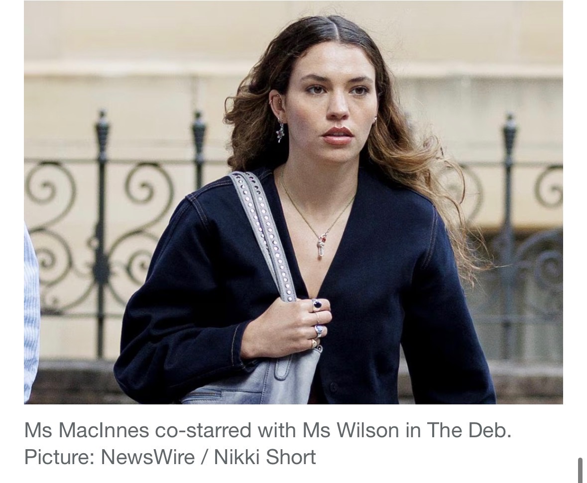 Charlotte MacInnes in deep navy V-neck top with cream shoulder bag, arriving at Federal Court of Australia · Week 2 trial